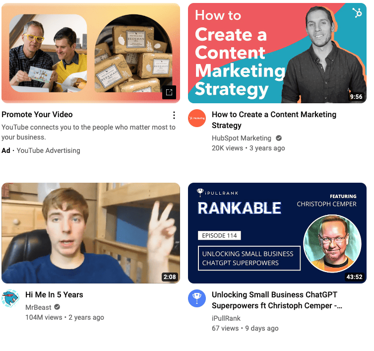  Four video thumbnails in a YouTube feed. The top left video is labeled “Ad - YouTube Advertising”. There is an image of two men examining stationery products next to another image of packages of products. The headline reads: “Promote Your Video”.